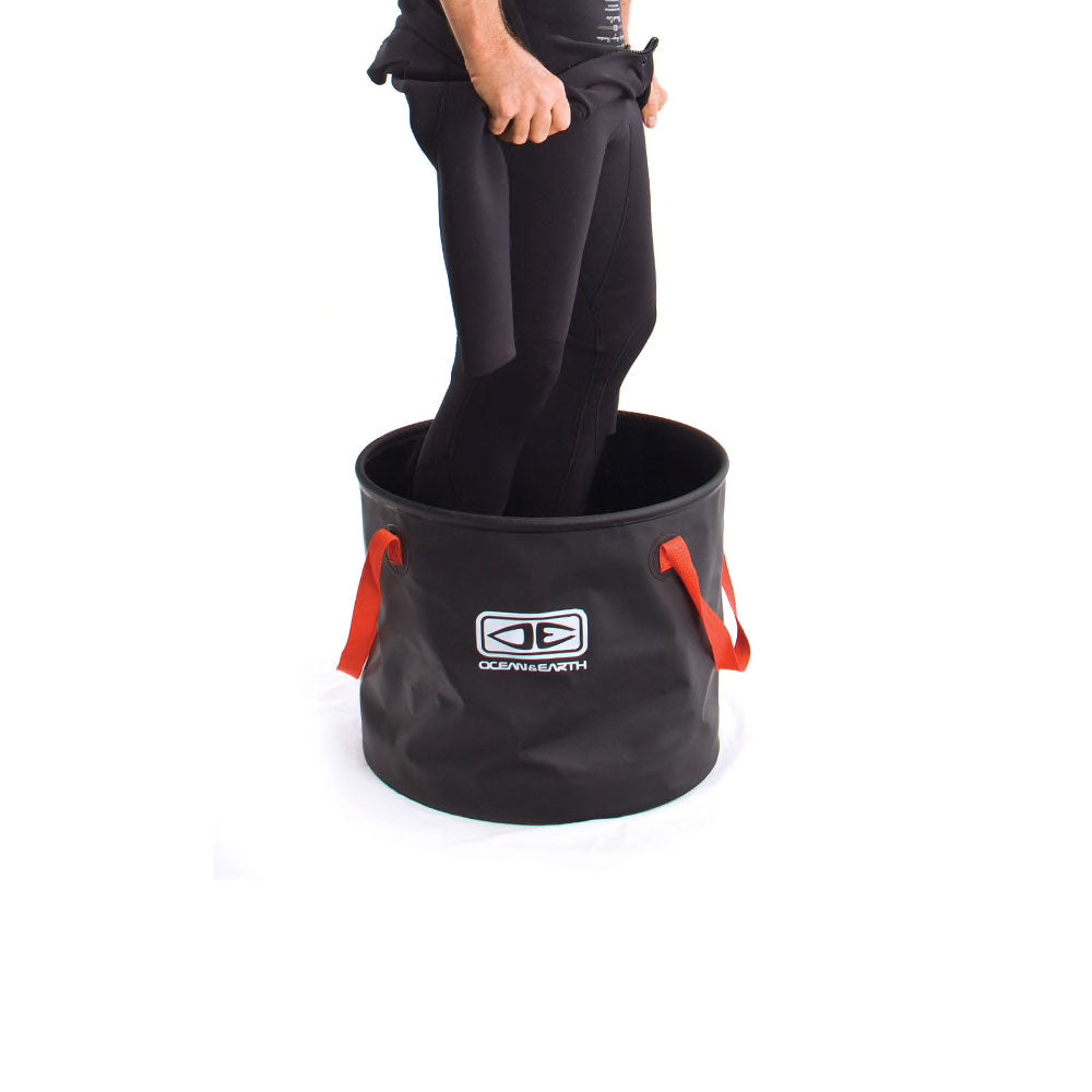 person-standing-in-wetsuit-bucket-ocean-and-earth-ireland